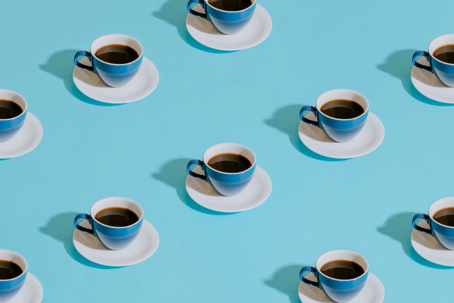Blue coffee cups on a teal background